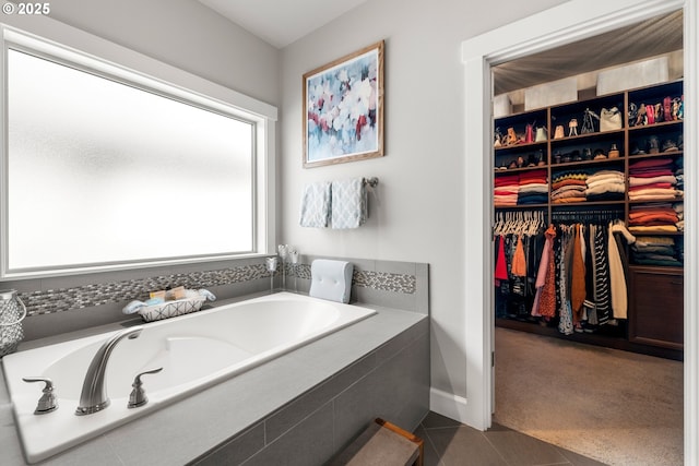 6244 SE Jess Ct, Hillsboro, OR 97123 - bathroom featuring tile patterned flooring, baseboards, a walk in closet, and a bath