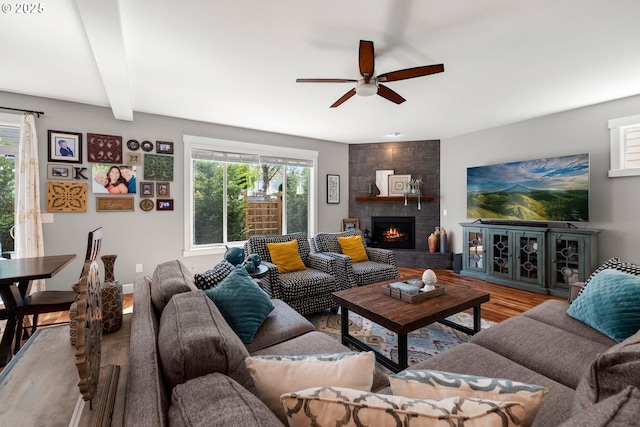 6244 SE Jess Ct, Hillsboro, OR 97123 - living area featuring beamed ceiling, ceiling fan, wood finished floors, and a large fireplace