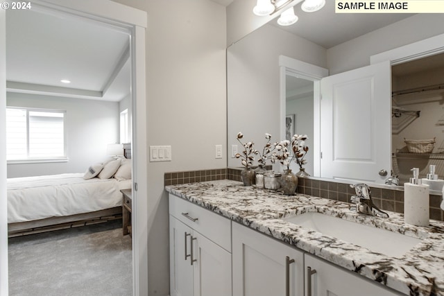 full bath featuring recessed lighting, tasteful backsplash, vanity, and ensuite bathroom