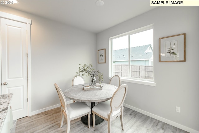 dining room with light wood-type flooring and baseboards