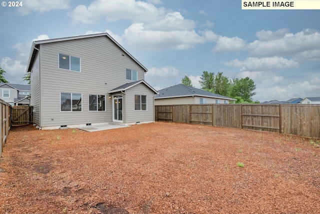 rear view of property with crawl space, a patio, and a fenced backyard