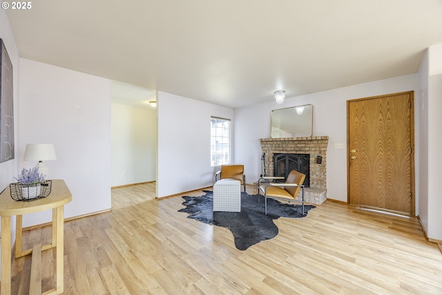 living area featuring a brick fireplace and wood finished floors