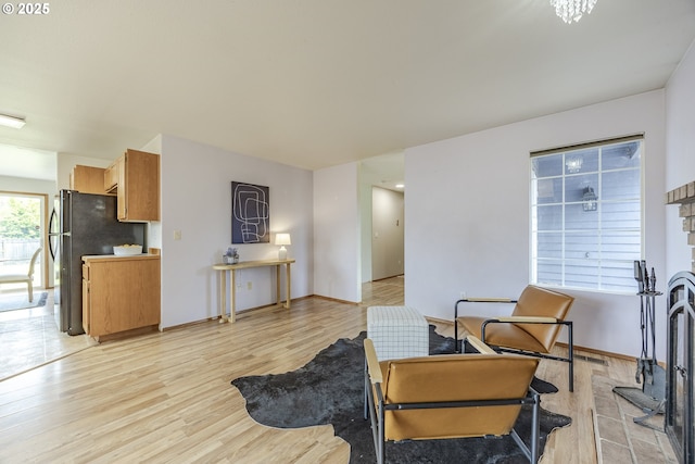 living area with visible vents and light wood finished floors