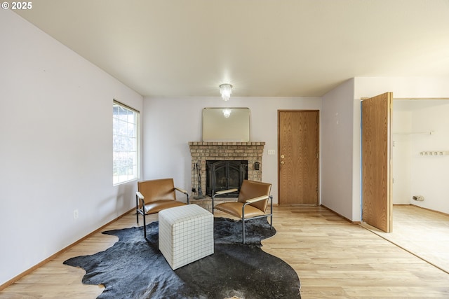 living area featuring light wood-style floors and a fireplace