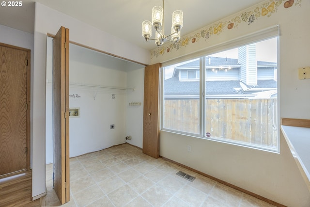 unfurnished dining area with an inviting chandelier and visible vents