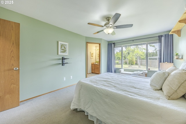bedroom with baseboards, a ceiling fan, carpet, and ensuite bathroom