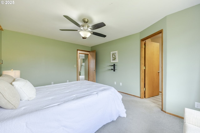 bedroom with light colored carpet, a ceiling fan, and baseboards