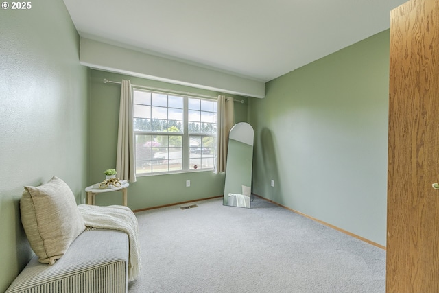living area featuring carpet flooring, baseboards, and visible vents