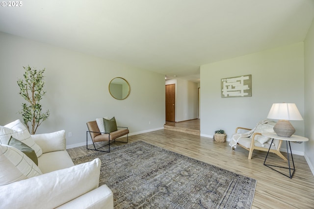 living room with baseboards and light wood-style flooring