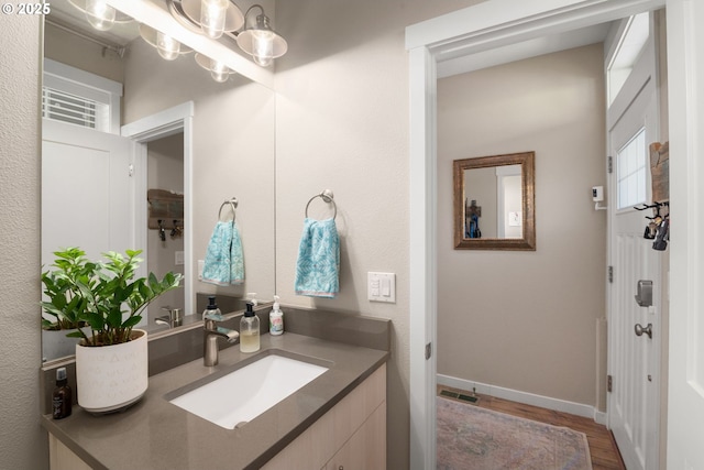6910 SE Lamphier St, Milwaukie, OR 97222 - bathroom with vanity, wood finished floors, and baseboards