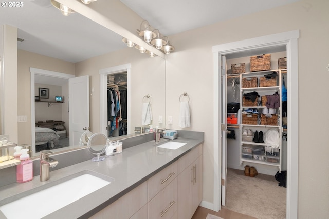 6910 SE Lamphier St, Milwaukie, OR 97222 - bathroom featuring connected bathroom, a walk in closet, and double vanity