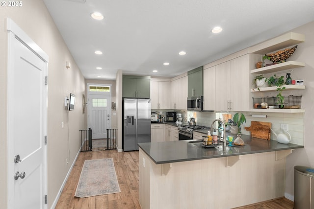 6910 SE Lamphier St, Milwaukie, OR 97222 - kitchen with stainless steel appliances, a peninsula, open shelves, dark countertops, and recessed lighting