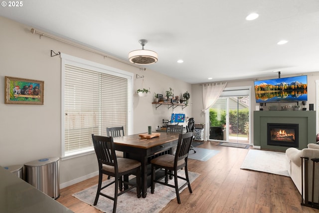 6910 SE Lamphier St, Milwaukie, OR 97222 - dining area featuring hardwood / wood-style floors, a glass covered fireplace, recessed lighting, and baseboards
