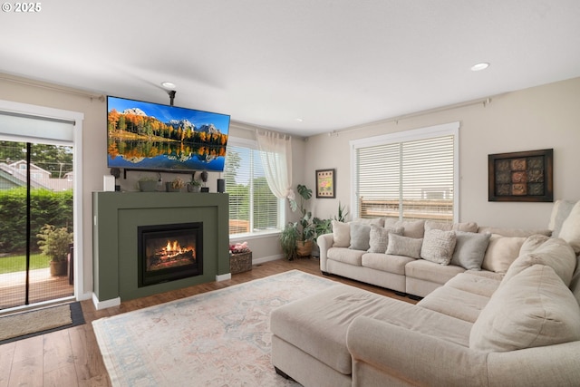 6910 SE Lamphier St, Milwaukie, OR 97222 - living area with plenty of natural light, recessed lighting, a glass covered fireplace, wood finished floors, and baseboards