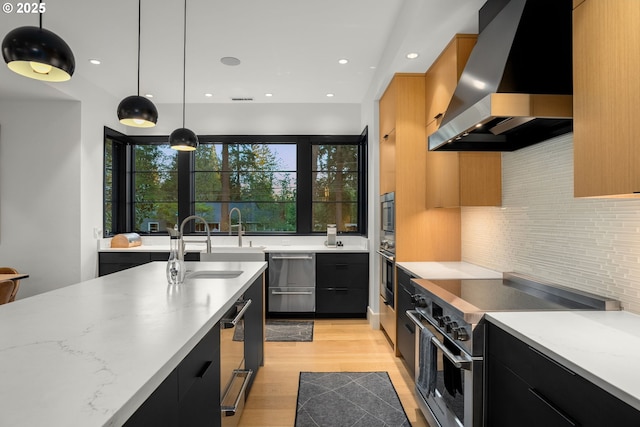1235 Andrews Rd, Lake Oswego, OR 97034 - kitchen with wall chimney exhaust hood, stainless steel appliances, modern cabinets, dark cabinetry, and tasteful backsplash
