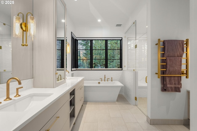 1235 Andrews Rd, Lake Oswego, OR 97034 - full bathroom featuring a freestanding bath, a towel warming rack, a stall shower, double vanity, and recessed lighting