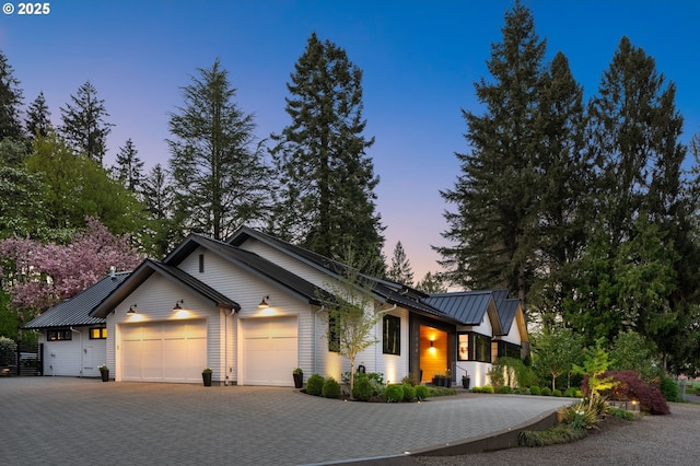 1235 Andrews Rd, Lake Oswego, OR 97034 - view of front of house with a garage, decorative driveway, a standing seam roof, and a metal roof