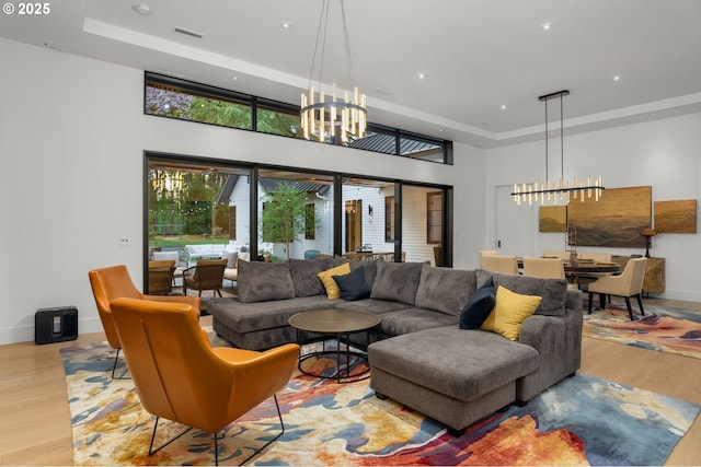 1235 Andrews Rd, Lake Oswego, OR 97034 - living area with a chandelier, a raised ceiling, wood finished floors, a high ceiling, and recessed lighting