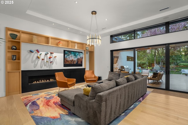 1235 Andrews Rd, Lake Oswego, OR 97034 - living area with a tray ceiling, recessed lighting, wood finished floors, a chandelier, and a towering ceiling