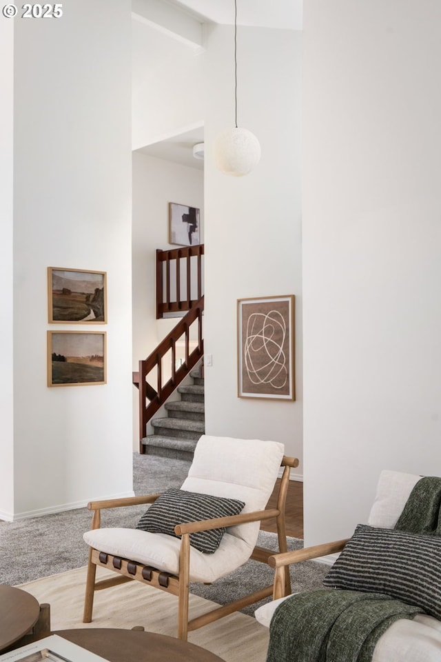 interior space featuring baseboards, lofted ceiling with beams, stairs, and wood finished floors