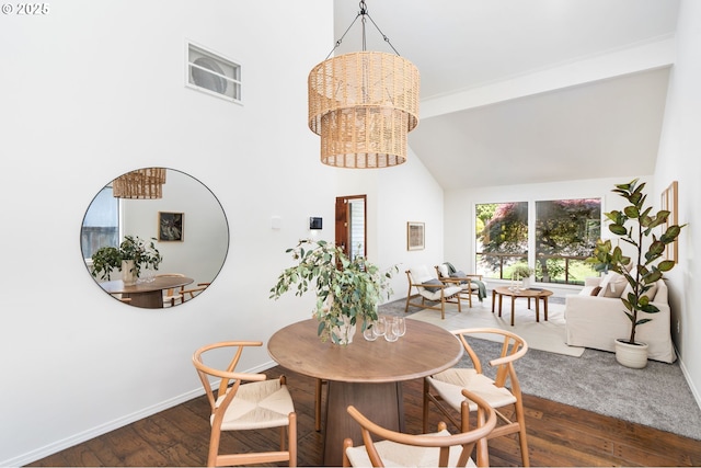 dining space with beam ceiling, wood finished floors, baseboards, high vaulted ceiling, and a notable chandelier