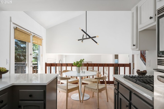 kitchen with light countertops, vaulted ceiling, light wood finished floors, and gas stovetop
