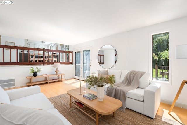 living area with wood finished floors and visible vents