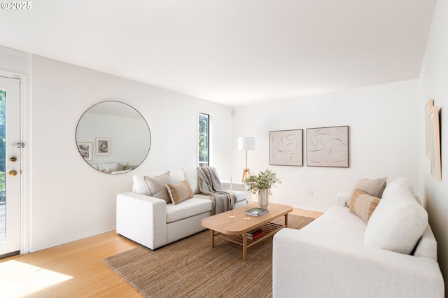 living room with baseboards and light wood finished floors