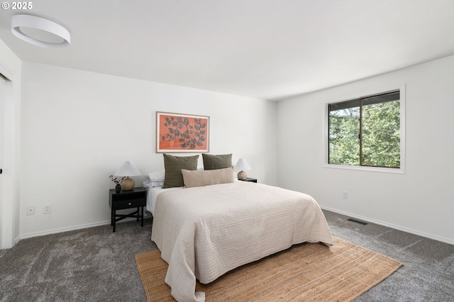 bedroom featuring baseboards, visible vents, and carpet