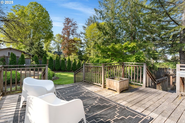 wooden terrace featuring a fenced backyard