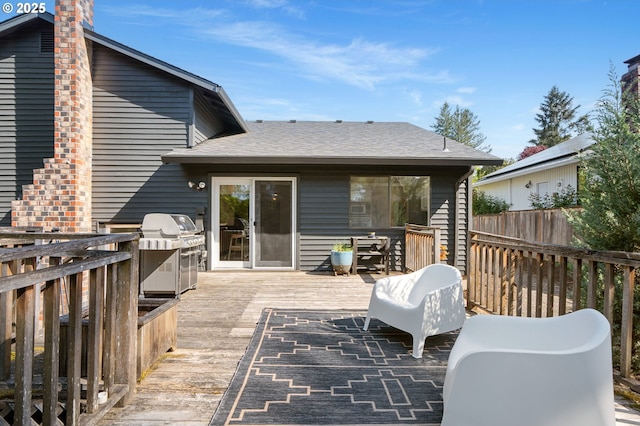 wooden deck with fence and grilling area