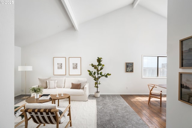 living area featuring baseboards, hardwood / wood-style floors, high vaulted ceiling, and beamed ceiling