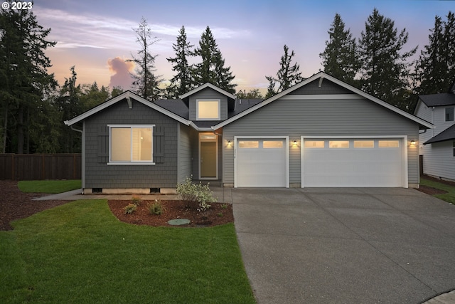 view of front of house featuring a yard and a garage