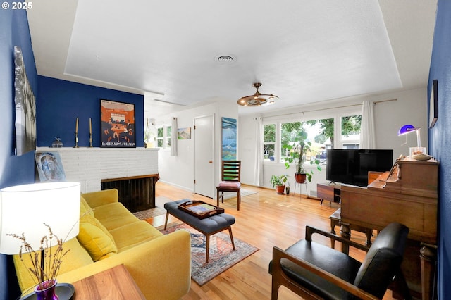 2940 Pearl St, Eugene, OR 97405 - living room featuring wood finished floors and a brick fireplace