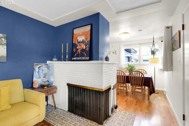 2940 Pearl St, Eugene, OR 97405 - living room featuring wood finished floors and a multi sided fireplace