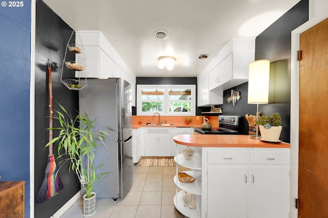 2940 Pearl St, Eugene, OR 97405 - kitchen featuring appliances with stainless steel finishes, open shelves, light tile patterned flooring, and white cabinets