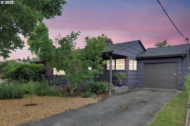 2940 Pearl St, Eugene, OR 97405 - view of front of home featuring concrete driveway, a garage, and a chimney