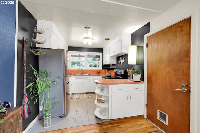 2940 Pearl St, Eugene, OR 97405 - kitchen with freestanding refrigerator, stove, open shelves, white cabinetry, and light countertops
