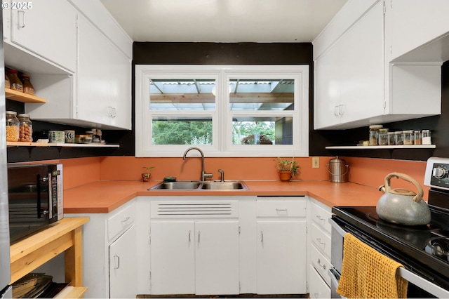 2940 Pearl St, Eugene, OR 97405 - kitchen with electric stove, open shelves, and white cabinets