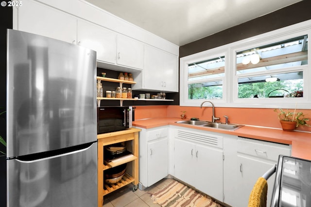 2940 Pearl St, Eugene, OR 97405 - kitchen with freestanding refrigerator, open shelves, black microwave, light tile patterned floors, and white cabinets