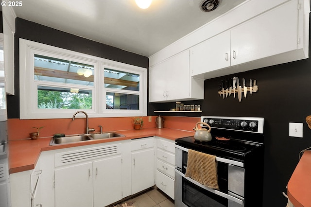2940 Pearl St, Eugene, OR 97405 - kitchen featuring double oven range, white cabinetry, light countertops, and light tile patterned floors