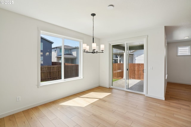 17109 NE 82nd St, Vancouver, WA 98682 - unfurnished dining area with baseboards, light wood-type flooring, and a chandelier