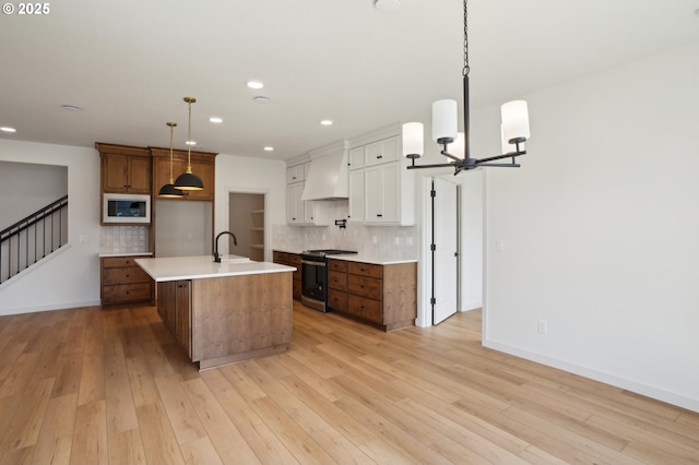 17109 NE 82nd St, Vancouver, WA 98682 - kitchen with backsplash, built in microwave, gas stove, premium range hood, and a sink