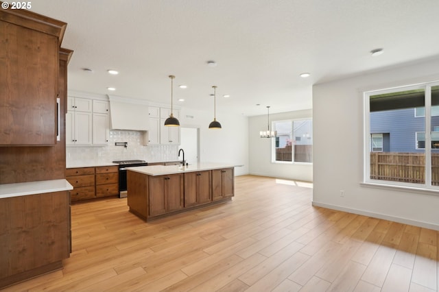 17109 NE 82nd St, Vancouver, WA 98682 - kitchen featuring stainless steel electric range, an inviting chandelier, a sink, light countertops, and decorative backsplash
