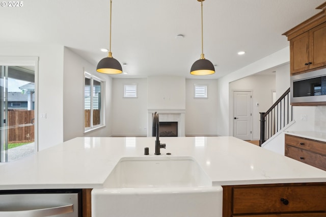 17109 NE 82nd St, Vancouver, WA 98682 - kitchen featuring brown cabinetry, a sink, appliances with stainless steel finishes, and a wealth of natural light