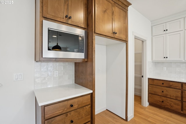 17109 NE 82nd St, Vancouver, WA 98682 - kitchen with light countertops, light wood-style flooring, stainless steel microwave, and backsplash