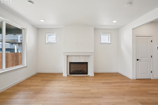 17109 NE 82nd St, Vancouver, WA 98682 - unfurnished living room with plenty of natural light, a tiled fireplace, and light wood-type flooring