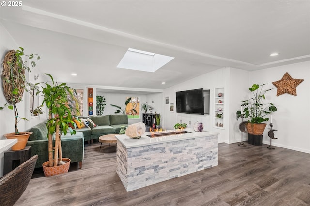 living room featuring dark wood finished floors, recessed lighting, lofted ceiling with skylight, and built in shelves