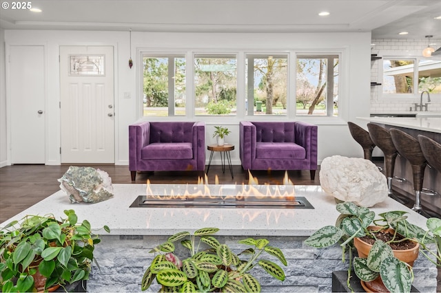 sunroom / solarium featuring a wealth of natural light and a sink