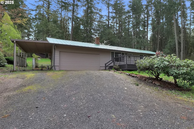 29652 Lusk Rd, Eugene, OR 97405 - view of front of house with metal roof, a chimney, an attached garage, and gravel driveway
